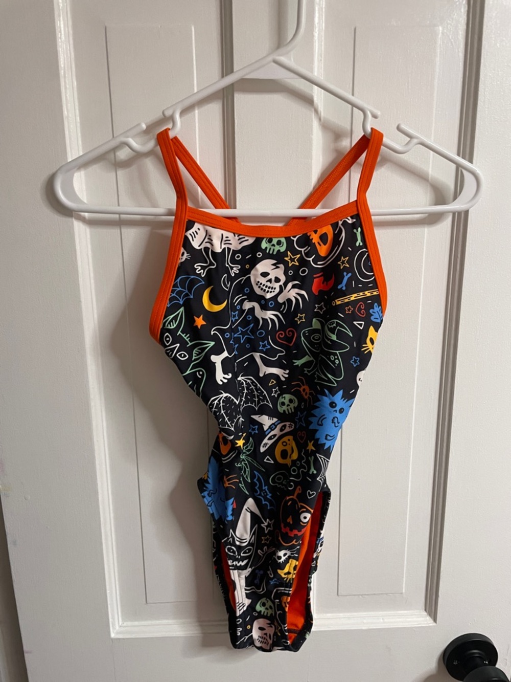 Kids Black Halloween Print One-Piece competitive Swimsuit with Orange Trim.